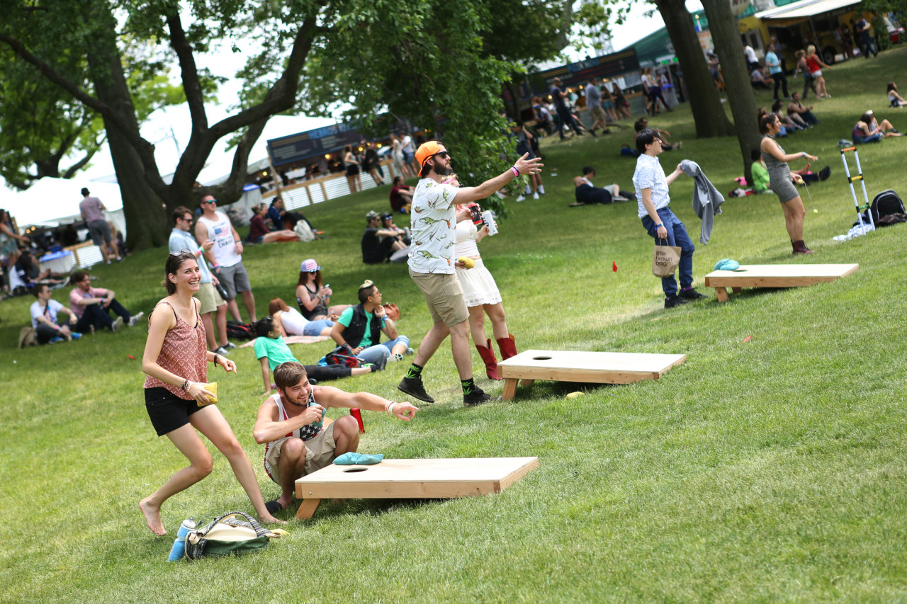 Festival goers playing cornhole early on Saturday afternoon at Governors Ball on Randall's Island, New York, on June 6, 2015. (© Michael Katzif – Do not use or republish without prior consent.)